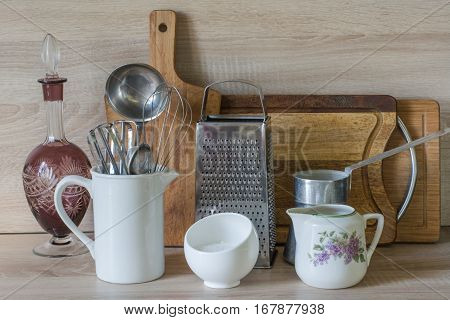 Crockery tableware utensils and other different stuff on wooden table-top.Kitchen still life as background for design. Image with copy space.
