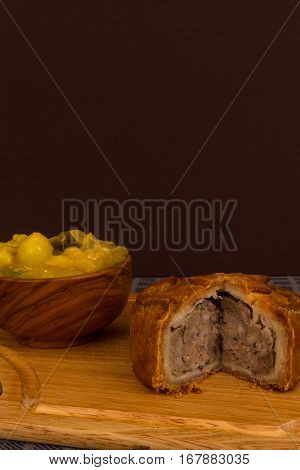 Game Pie Served With Bowl Of Piccalilli