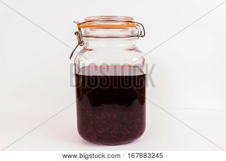 Blackberries in sherry maturing in resealable jar.