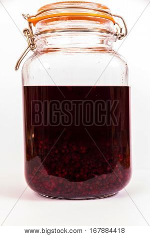 Blackberries in sherry maturing in resealable jar.