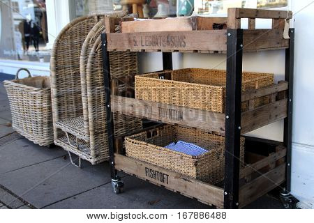 New Alresford, Uk - Jan 28 2017: Traditional Wooden And Wicker Trolley And Trays Outside A Shop In B