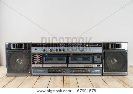vintage audio cassette tape deck ghettoblaster on wooden table.