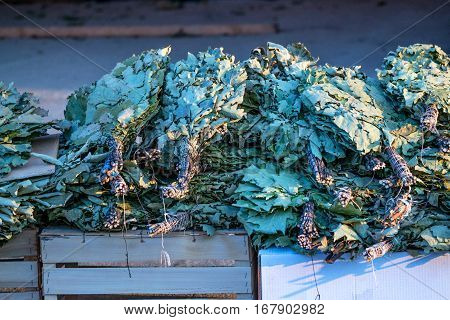 Photo of lot oak besoms for Russian banya at market place