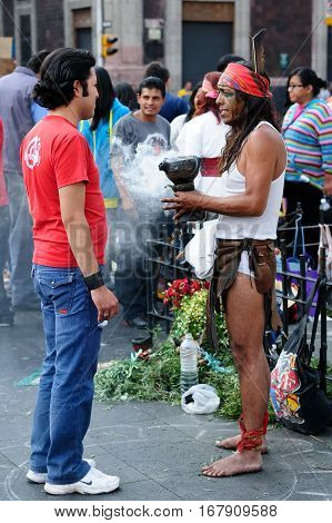 MEXICO MEXICO - FEBRUARY 16: Traditional Aztec shaman during the ceremony of cleaning which he is granting the resident of the capital city of Mexico on February 16 2013