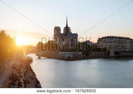 Cathedral of Notre Dame de Paris with Seine river at sunset. Paris France.