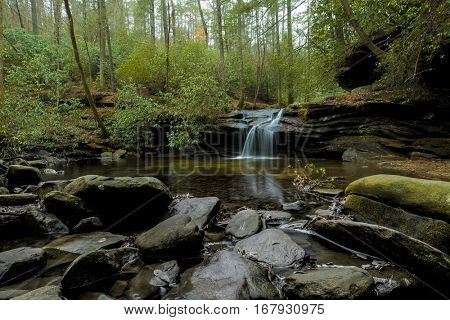 Waterfall, rocks, and forest in Table Rock State Park, South Carolina