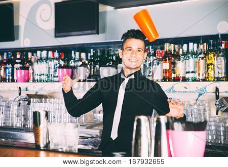 Flair bartender in action behind an american bar