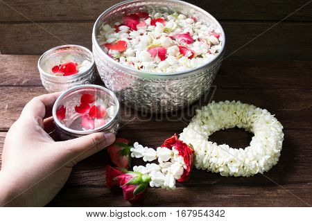 Water in bowl mixed with perfume and flowers corolla for Songkran festival in Thailand.