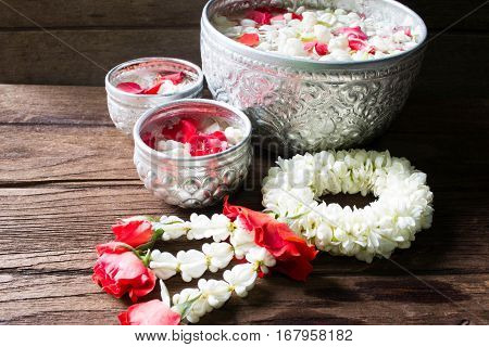 Water in bowl mixed with perfume and flowers corolla for Songkran festival in Thailand.