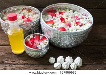 Water in bowl mixed with perfume and flowers corolla for Songkran festival in Thailand.