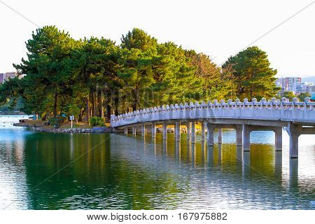 Bridge White cross the pond in the Fukuoka Ohori Park Japan