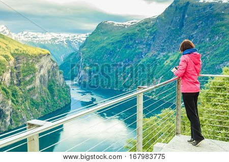 Tourist Looking At Geirangerfjord From Flydasjuvet Viewpoint Norway