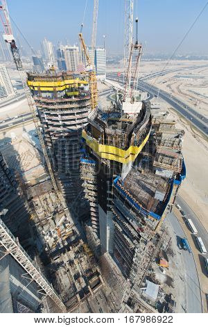 United Arab Emirates, Dubai, 05/21/2015, Damac Towers Dubai by Paramount, construction and building ariel views with cityscape background