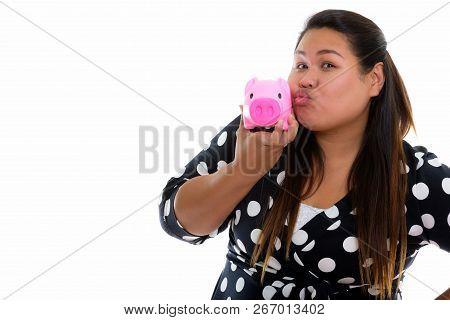 Studio Shot Of Young Fat Asian Woman Puckering Lips And Holding