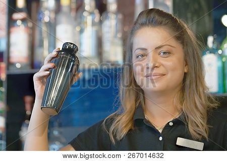 Professional Bartender Girl Holding In Hands A Shaker With A Fresh Delicious Cocktail. Barmaid Shaki