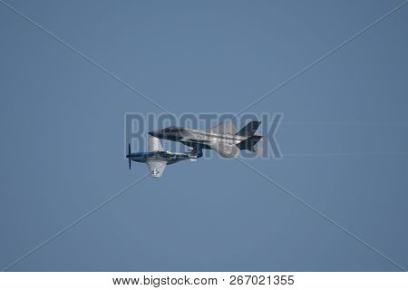 North American P-51 Mustang And Lockheed Martin F-35 Lightning Ii Flying Side By Side In A Heritage 