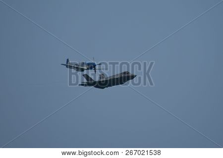 North American P-51 Mustang And Lockheed Martin F-35 Lightning Ii Flying Side By Side In A Heritage 