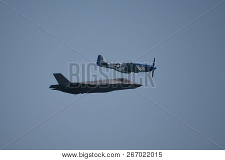 North American P-51 Mustang And Lockheed Martin F-35 Lightning Ii Flying Side By Side In A Heritage 