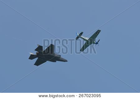 North American P-51 Mustang And Lockheed Martin F-35 Lightning Ii Flying Side By Side In A Heritage 