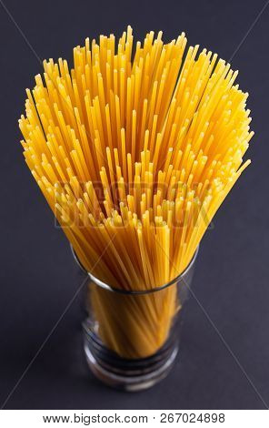 A Bouquet Of Spaghetti In Glass On A Dark Background