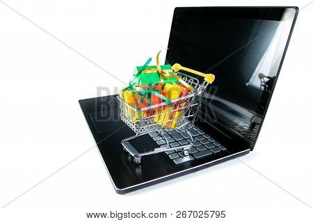 Ciber Monday Concept - Trolley Cart With Christmas Presents On Notebook, Isolated On White
