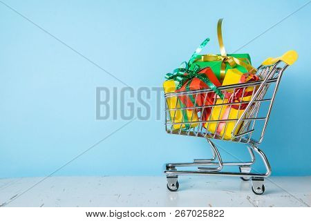 Ciber Monday Concept - Trolley Cart With Christmas Presents, Blue Background, Copy Space