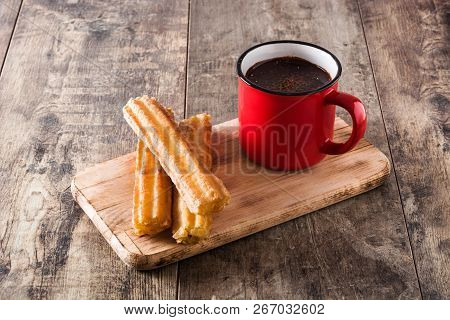 Hot Chocolate With Churros On Wooden Table.