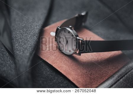 Watch On Wallet On Gray Coat Background