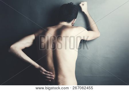 Young Man With Back And Neck Pain