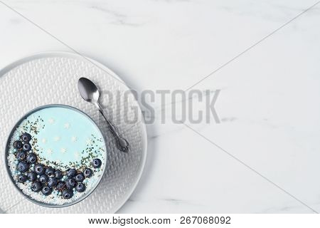 Top View Of Blue Yogurt Smoothie Bowl Made With Blueberry, Coconut Flour, Chia Seeds And Sugar Pearl