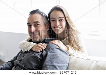 Teenager Girl Sitting On Window With Father