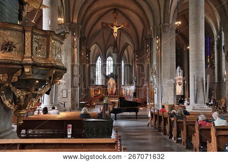 Linkoping, Sweden - August 25, 2018: People Visit The Romanesque Cathedral In Linkoping, Sweden. The