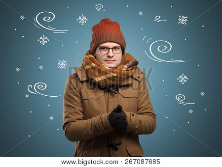 Young hipster frozen boy with doodled snowflakes and windy concept