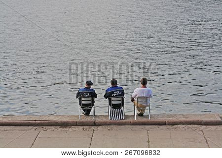 Moscow, Russia - July 31, 2011: Rear View Of Lifeguards Sitting In A Chair Near The Water On The Ban