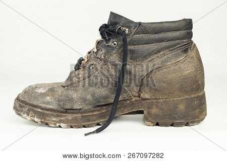 Worn-out Old Work Boot, Isolated On White Background With Shadow