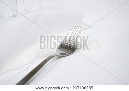 Silver Fork On Linin Luxury White Tablecloth Food Dinner With Glass Background