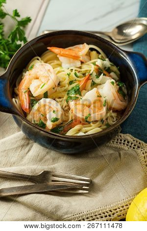 Shrimp Scampi With Angel Hair Pasta Surrounded By Cooking Ingredients