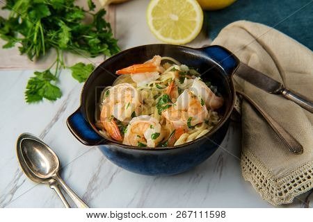 Shrimp Scampi With Angel Hair Pasta Surrounded By Cooking Ingredients