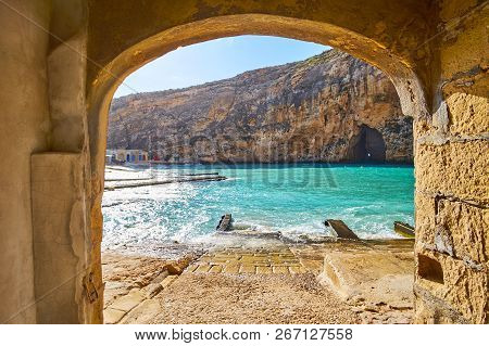 The View On Dwejra Inland Sea And The Blue Hole Grotto Through The Arch Of The Old Boat House Of San