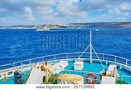 The Ferries, Running Between Malta And Gozo Islands, With A View On Dark Blue Waters, Heavy Clouds A