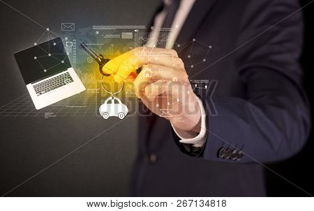 Businessman in suit holding keys with statistics, graphs and icons around