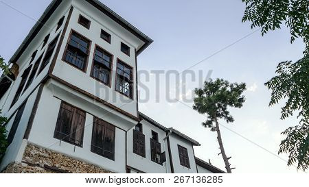 Green Trees Near The Stone House Of Alanya, Turkey. Trees And Old Buildings. Summer Concept And Copy