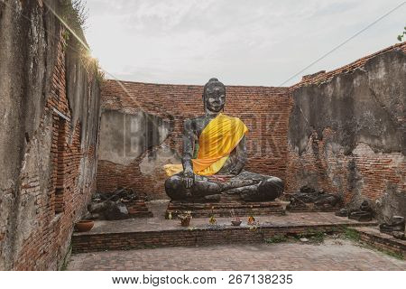 Sitting Buddha Sculpture With Golden Cassock In Wat Wora Chet Tha Ram Temple, Ayutthaya, Thailand On