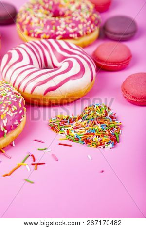 Donuts, Confectionery Heart And Macaroons On A Pink Background. Delicious Desser Delicious Dessert.