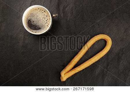 A Photo Of Black Coffee In A Vintage Cup And Traditional Spanish Churros, A Typical Sunday Breakfast