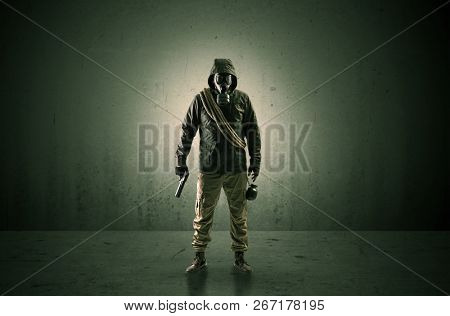Bad agent in a dark room with arms on his hand and gas mask