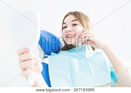 Dental Clinic. Reception, Examination Of The Patient. Teeth Care. Young Girl Smiling, Looking In The