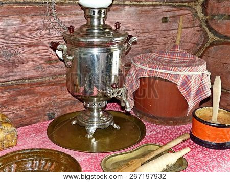 Rustic Cuisine. The Samovar Is On The Table. Interior Of A Peasant Izba. Closeup. Retro. Selective F