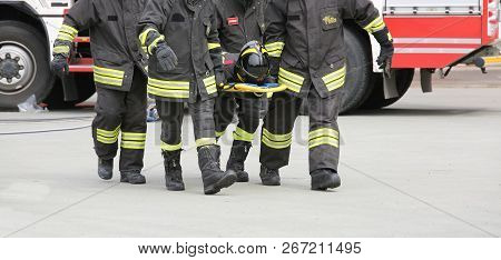Italia, Italy - May 10, 2018: Four Italian Stretcher Bearers Firefighters Transport An Injured On Th