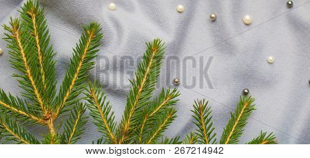 Green Branches Of Spruce With A Cozy Warm Knitted Scarf, Place For Text. Rustic Christmas Tree And W